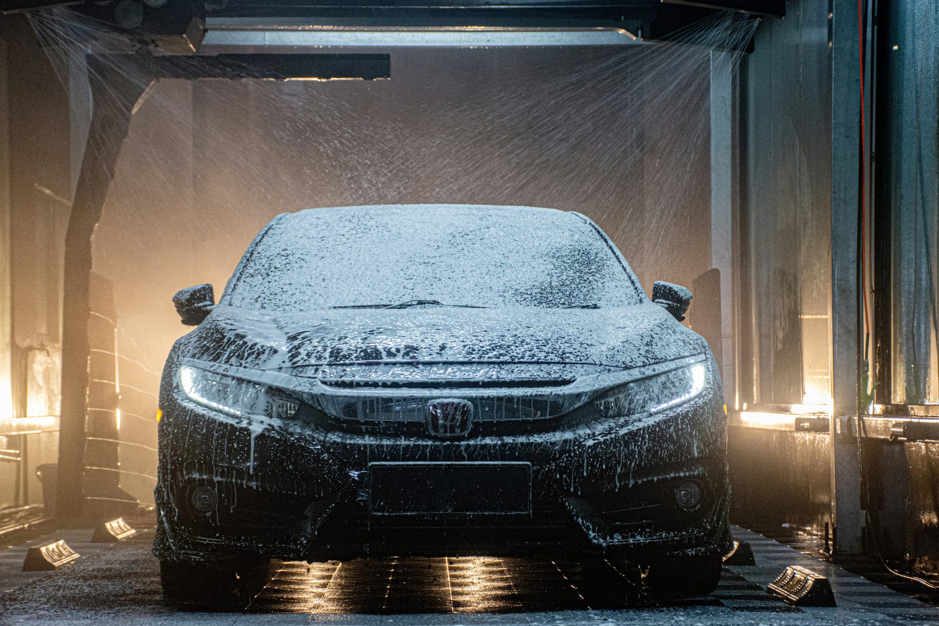 a car is covered in snow in a garage